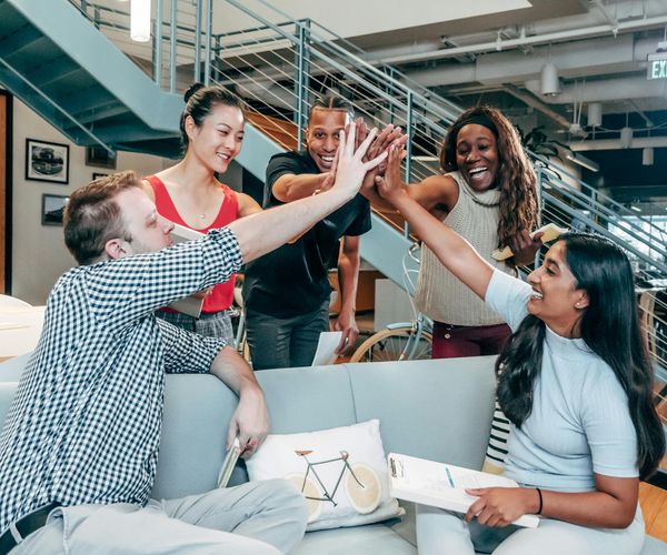 Diverse group of office workers smiling during a wellness workshop.